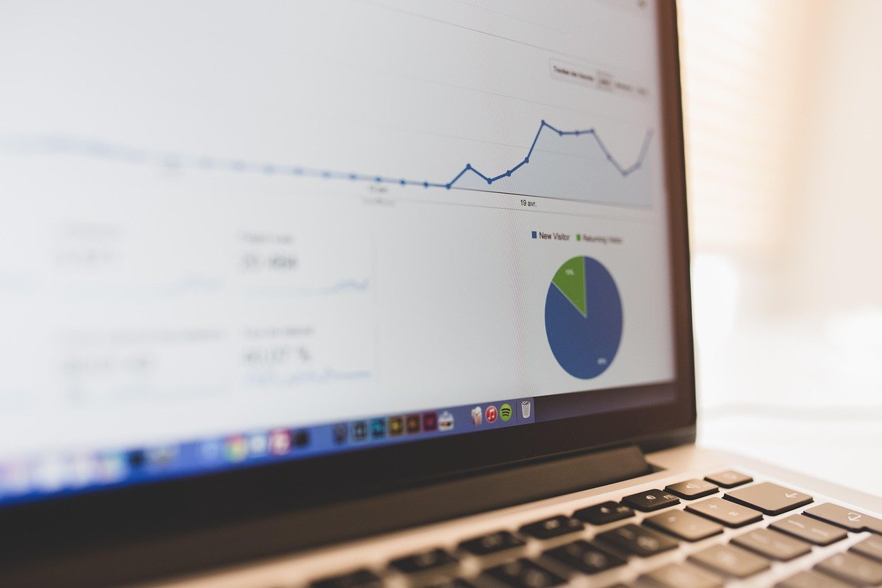 Business charts and reports open on a laptop screen